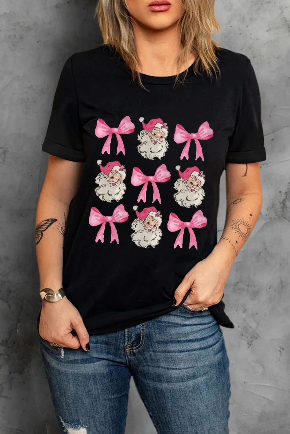 Black t-shirt with Santa and pink bow grid graphic, crew neck, short sleeves.