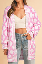 Diamond jacquard knit open cardigan in blush pink with pockets and ribbed cuffs.