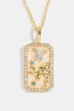 Gold plated Taurus zodiac sign crystal pendant necklace with enamel and gemstones.
