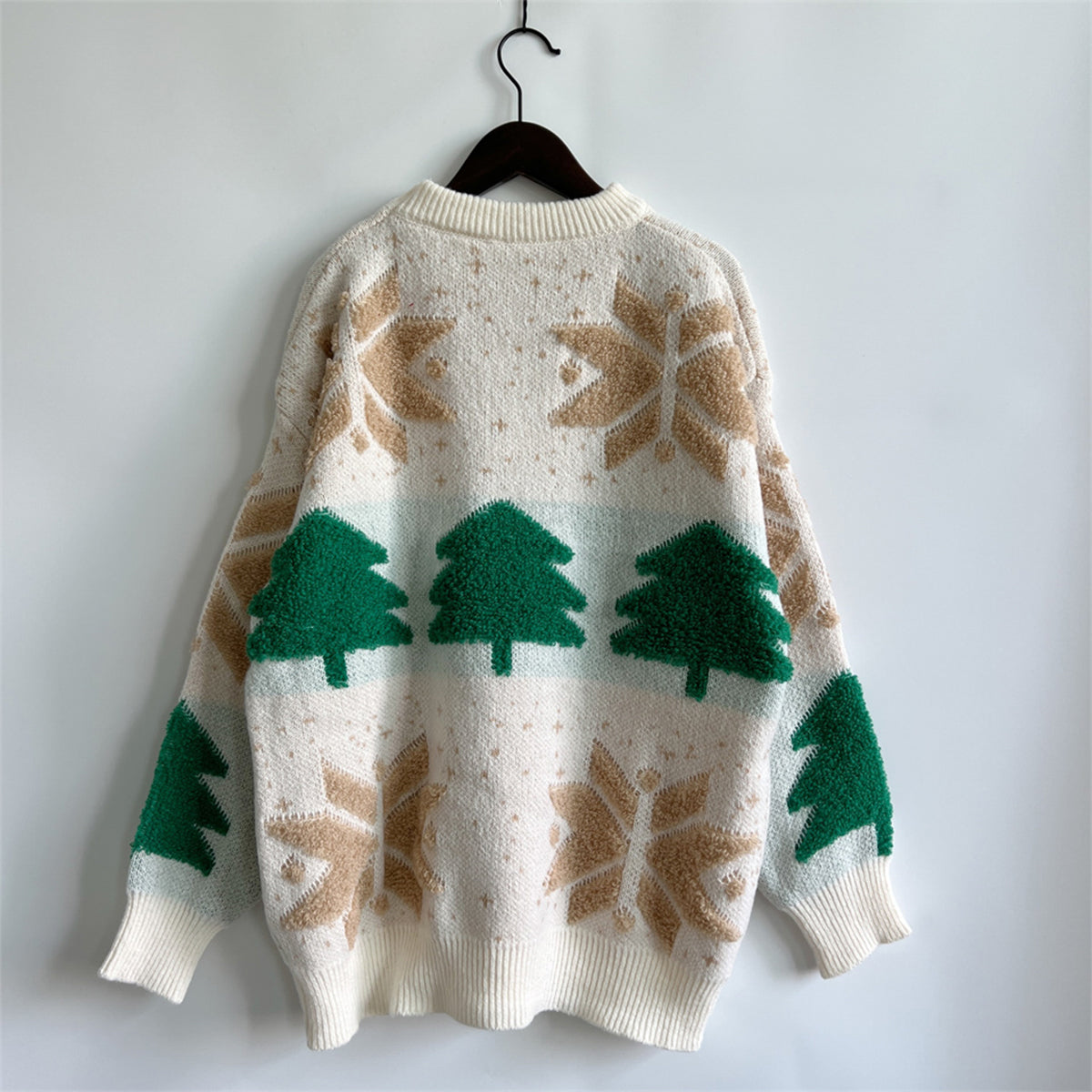 Cream knit sweater with green Christmas trees and tan snowflake appliqué.