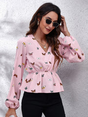 Blush pink peplum blouse with cinched waist and allover butterfly print, V-neck, balloon sleeves.