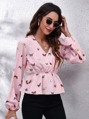 Blush pink peplum blouse with cinched waist and allover butterfly print, V-neck, balloon sleeves.