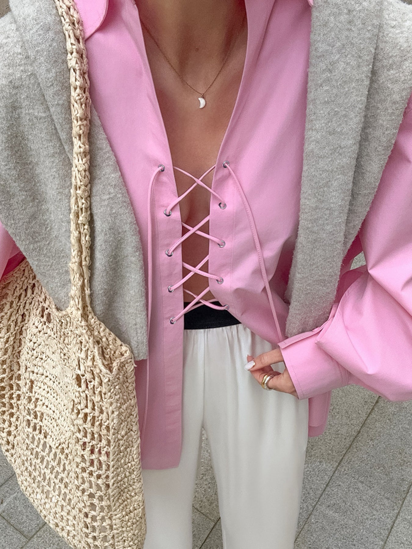 Pink cotton lace-up front relaxed fit shirt with a deep V-neckline.