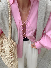 Pink cotton lace-up front relaxed fit shirt with a deep V-neckline.