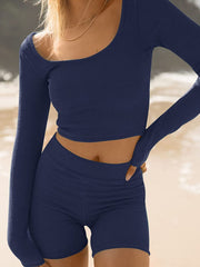 Textured ribbed scoop neck crop top and shorts set in dark blue, showing a close-up of the neckline and waist.