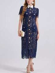 Navy lace midi dress with white collar, gold buttons, short sleeves, and pockets.
