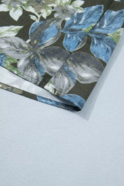 Botanical print cotton shirt with ruffle sleeves and a dark floral pattern.