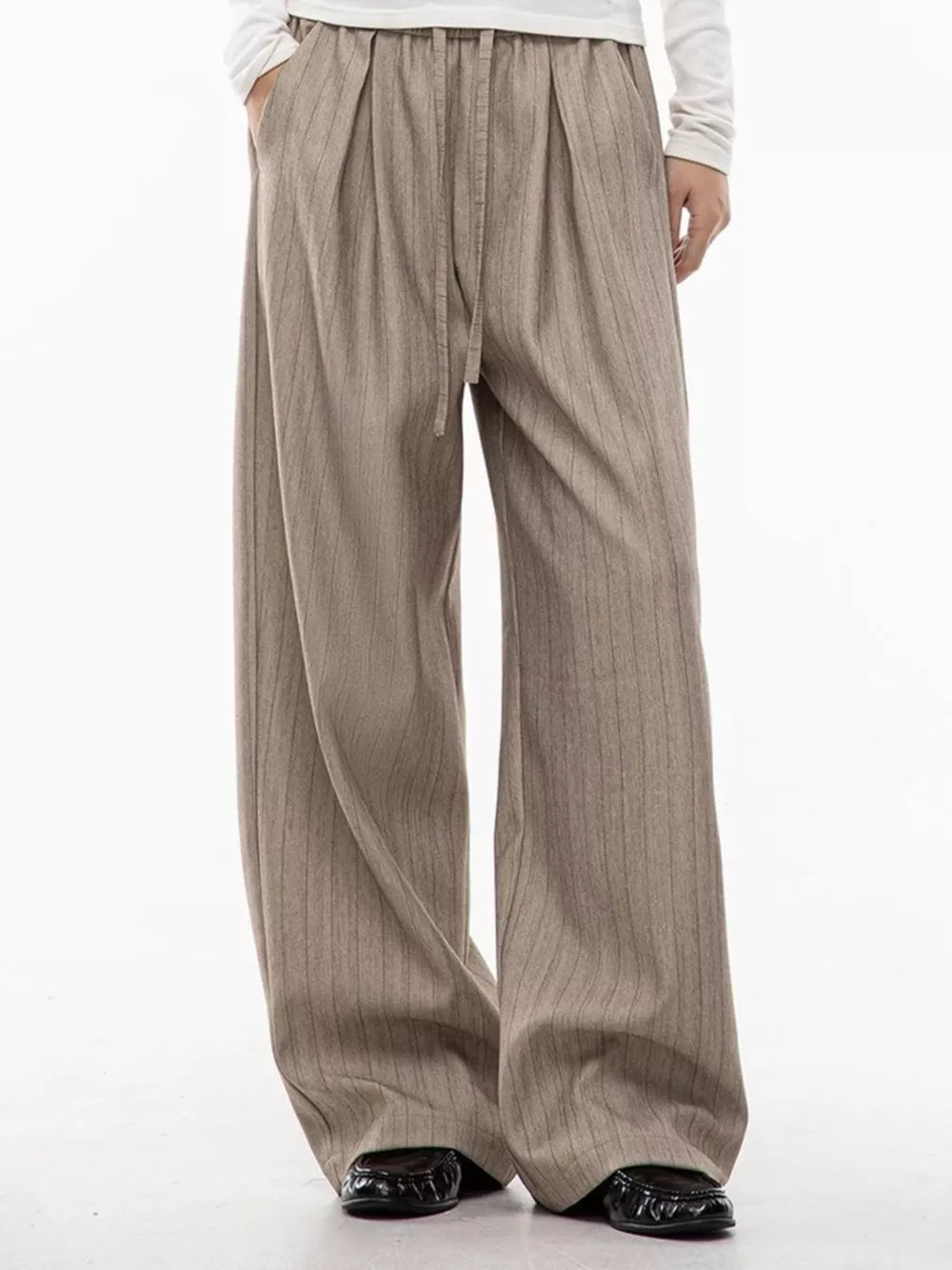 Khaki wide-leg pleated trousers with pinstripes and drawstring waist.