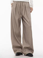 Khaki wide-leg pleated trousers with pinstripes and drawstring waist.