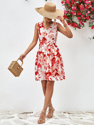 Watercolor floral tiered mini dress in deep red with V-neck and belted waist.