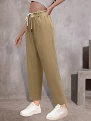 Khaki wide-leg trousers with drawstring waist and belt detail.