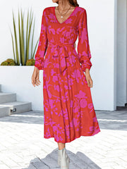 Tiered midi dress in hot pink floral print with V-neck and tie waist.