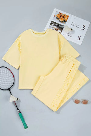 Yellow cotton embroidered half-sleeve top and drawstring pants set with eyelet details.