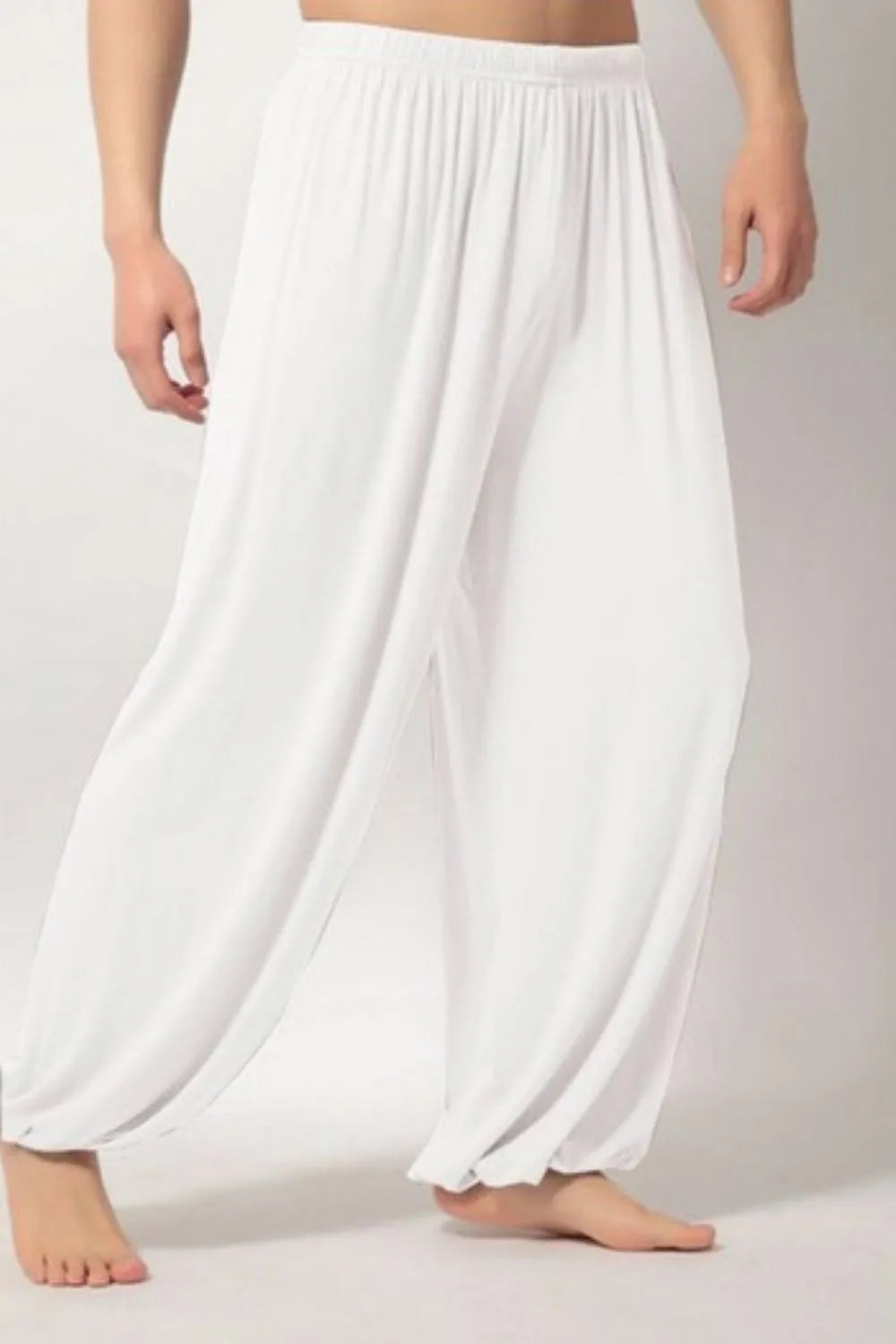 White relaxed drape harem pants with elastic waistband and cuffed ankles.