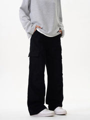 Black cargo pants with versatile pockets and a relaxed fit, styled with a grey sweatshirt.