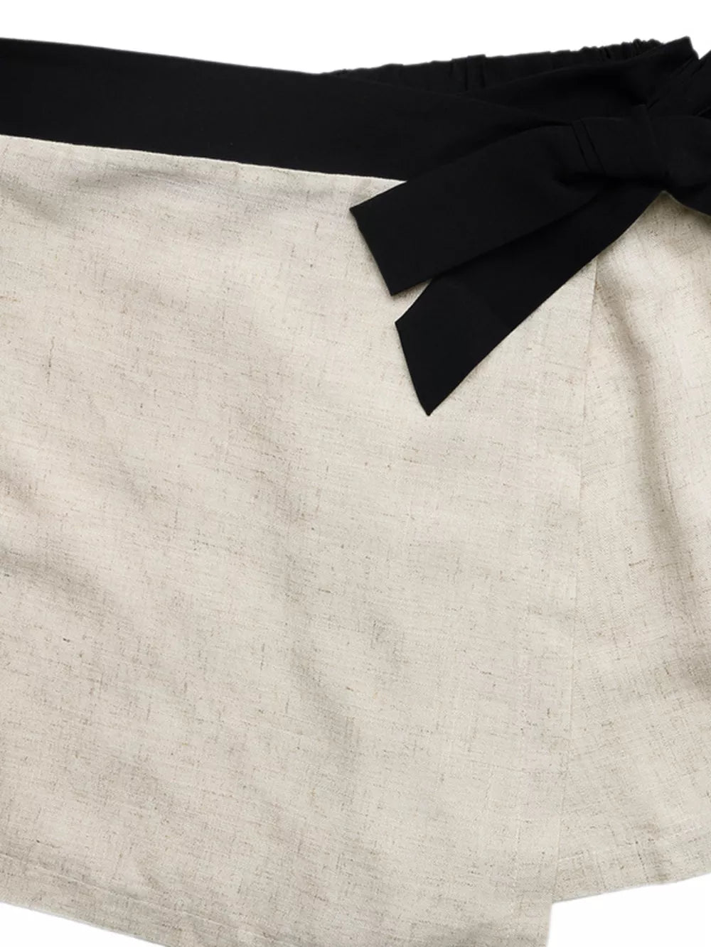 Linen-blend cami and skort ensemble with black contrast trim and bow detail.