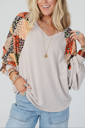 Light gray patchwork raglan sleeve top with a V-neck and animal print panels.