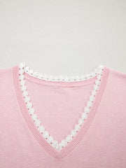 Pink knit v-neck top with white lace trim detail