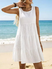 White tiered mini dress with vertical texture, sleeveless, round neck, above knee length