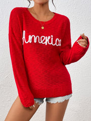 Red knit sweater with embroidered "America" detail, crew neck, long sleeves.
