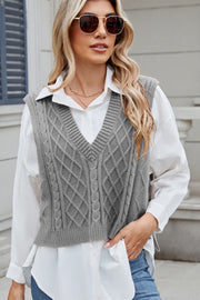 Gray cable knit diamond pattern sweater vest with V-neck, styled over a white collared shirt.