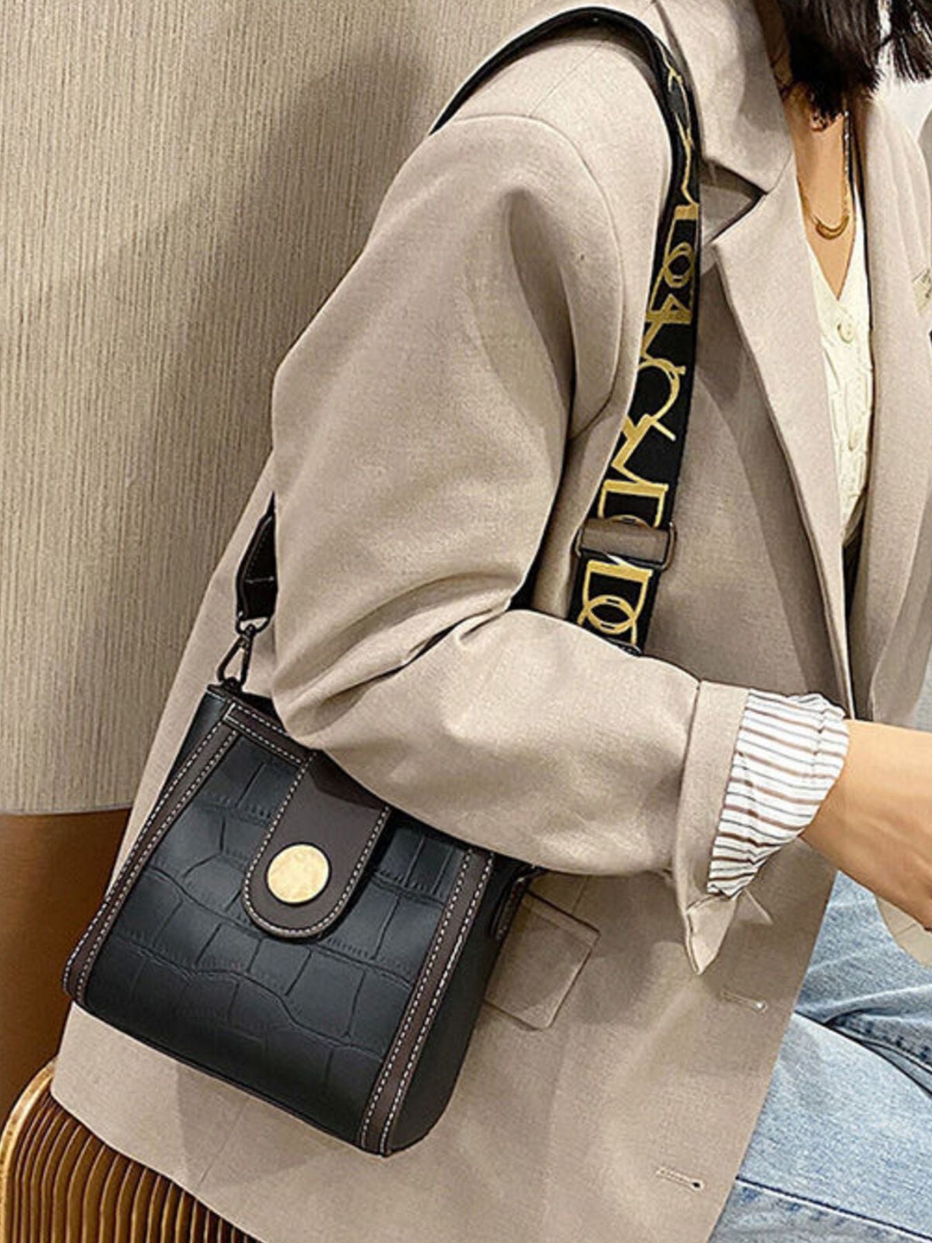 Black crocodile pattern mini crossbody bag with gold button detail and logo strap.