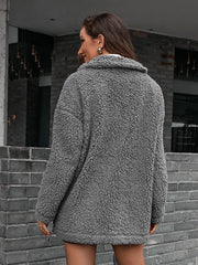 Gray teddy moto jacket with collared neckline and asymmetrical detail.