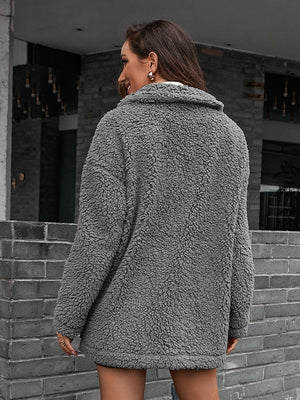 Gray teddy moto jacket with collared neckline and asymmetrical detail.