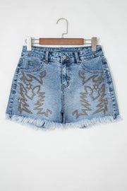 Embroidered denim shorts with distressed frayed hem and western boot design.