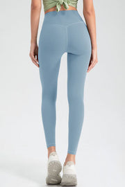 Misty Blue high rise leggings with V-seam detail and white athletic sneakers.