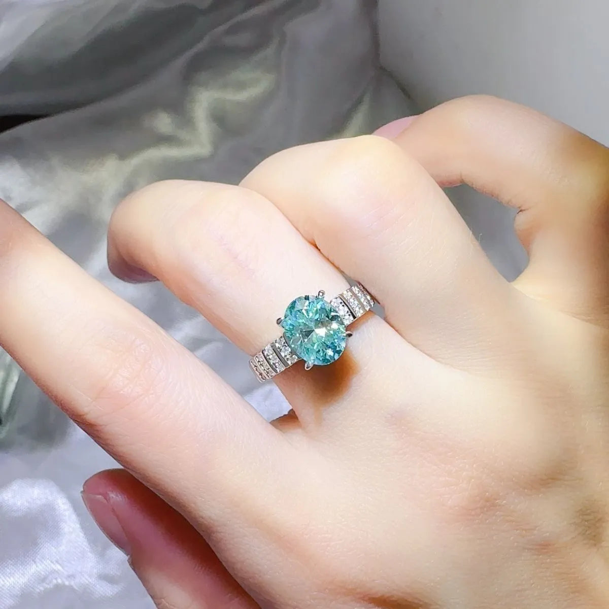 Aquamarine halo oval ring with diamond band in turquoise.