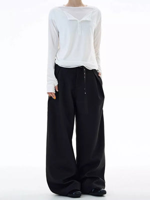 Black plus size wide-leg sweatpants with a belted waist and button detail.
