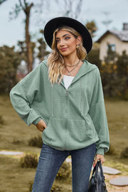 Sage textured cable knit zip-up hoodie with drawstring hood and pockets.