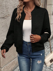 Black geometric quilted bomber jacket with a round neckline and zip front.