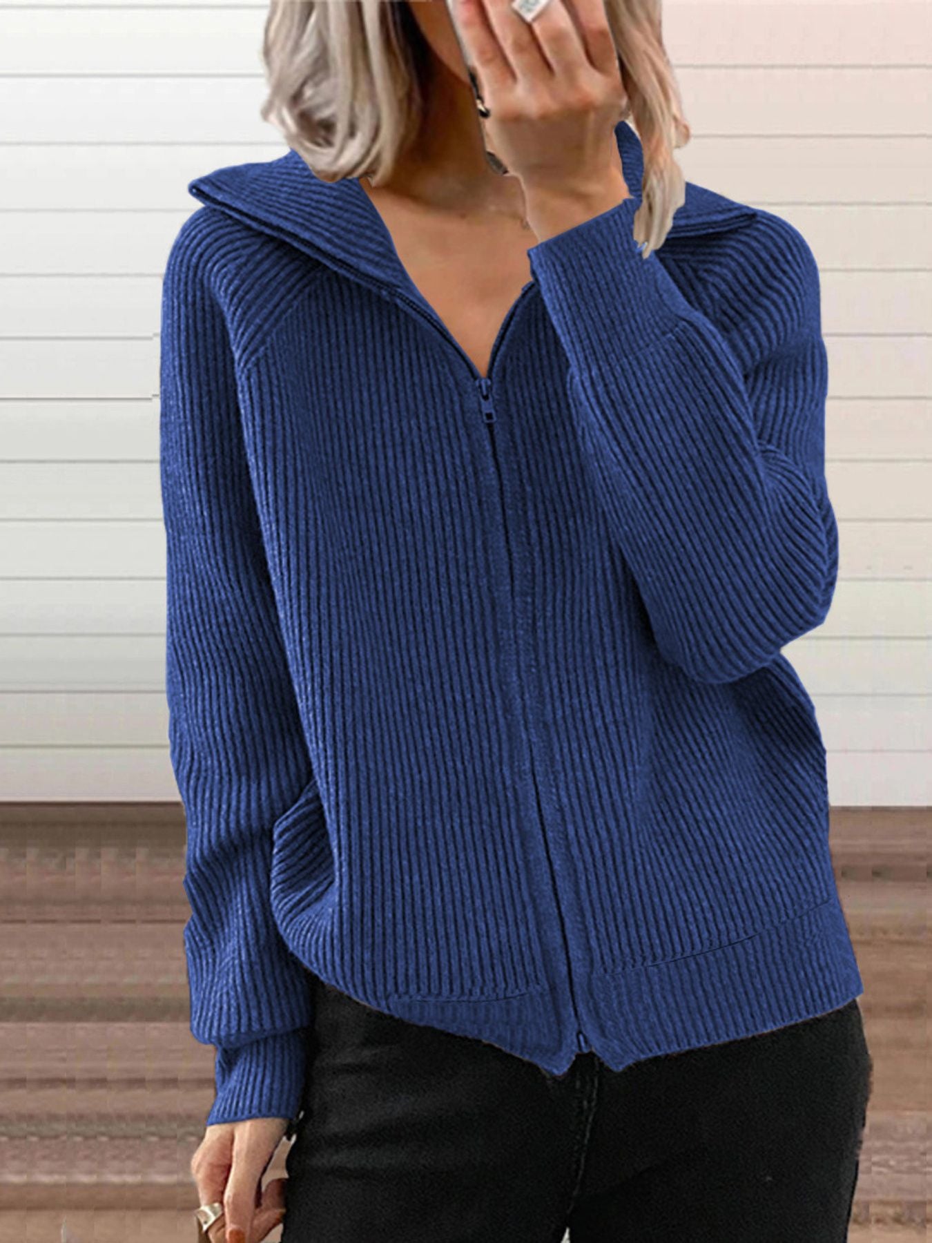 Blue ribbed knit zip-up trench coat with collar and pockets.