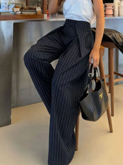Wide-leg pants in dark blue with white pinstripes, featuring a high waist and flowing silhouette.