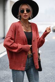 Textured bouclé button-down cardigan in rust with a relaxed fit.