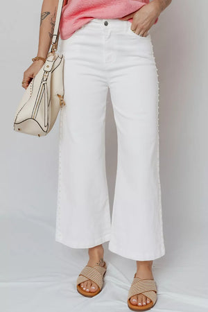 White denim relaxed fit ankle jeans with pearl embellishments down the side seams.