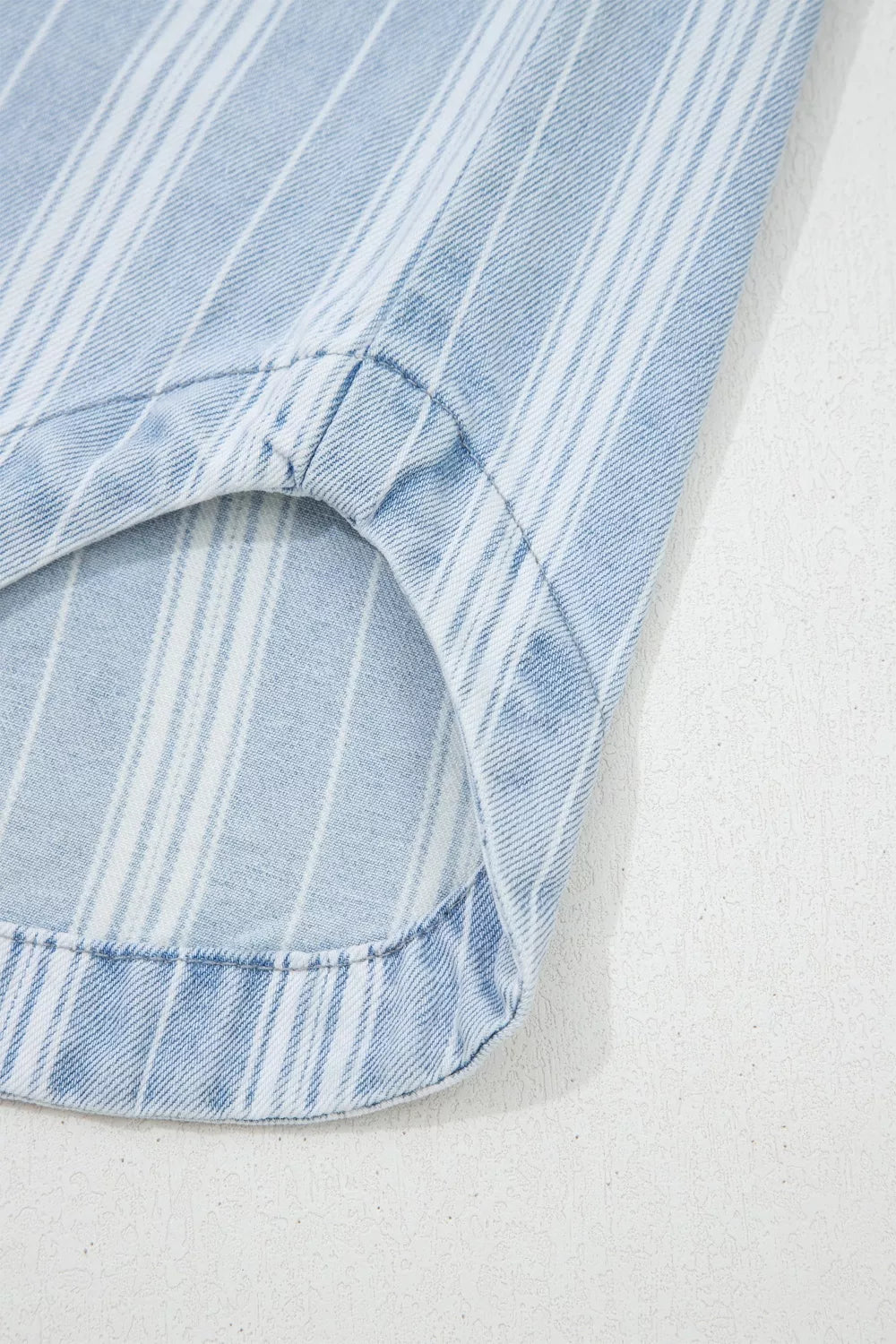 Relaxed stripe denim shacket with pocket detail, light blue and white vertical stripes.