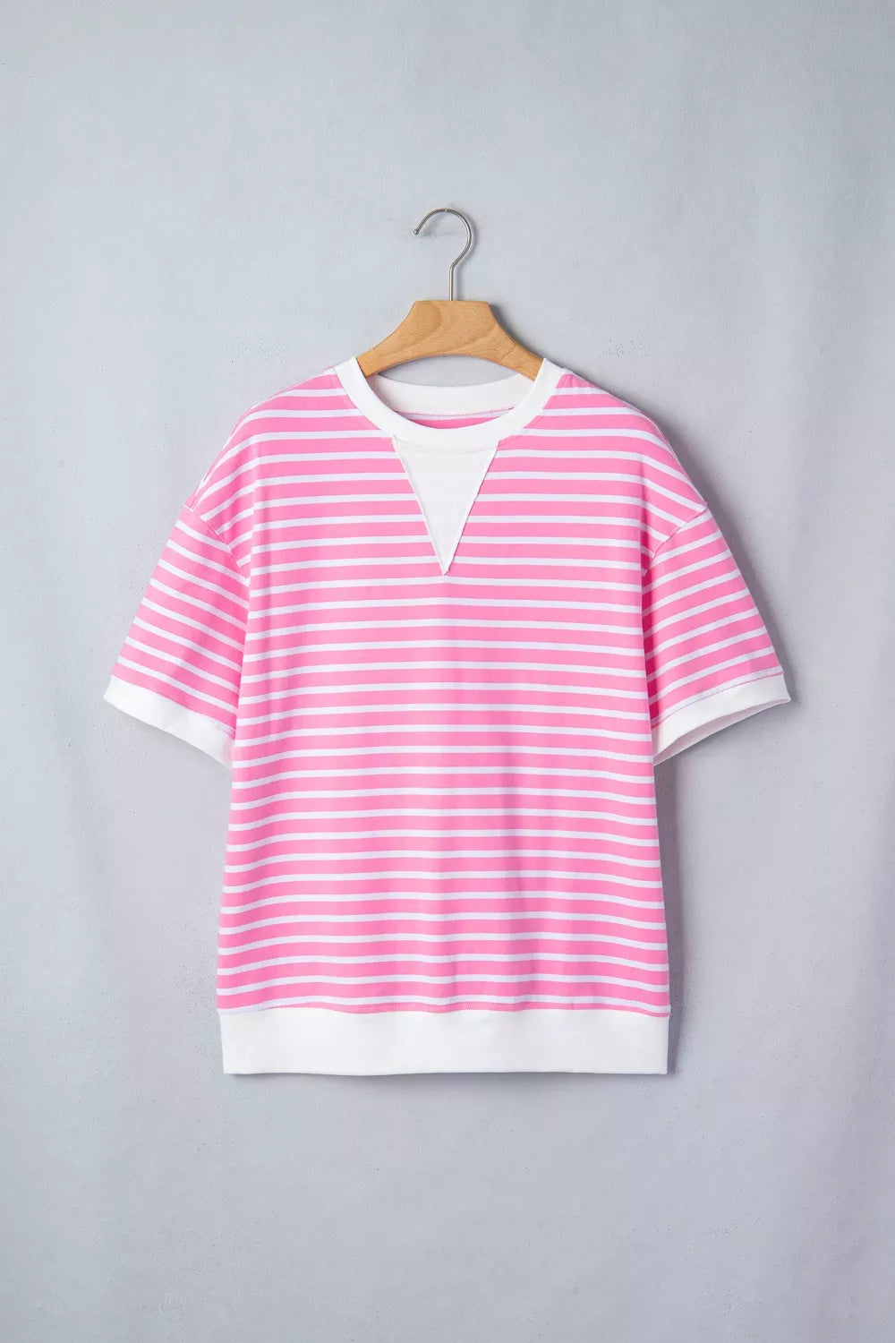 Pink and white striped cotton t-shirt with round neck and short sleeves.