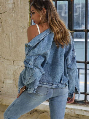 Light wash oversized denim jacket with buttoned patch pockets, worn open.
