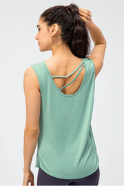 Strappy back performance tank top in turquoise with a scoop neckline and side slits.