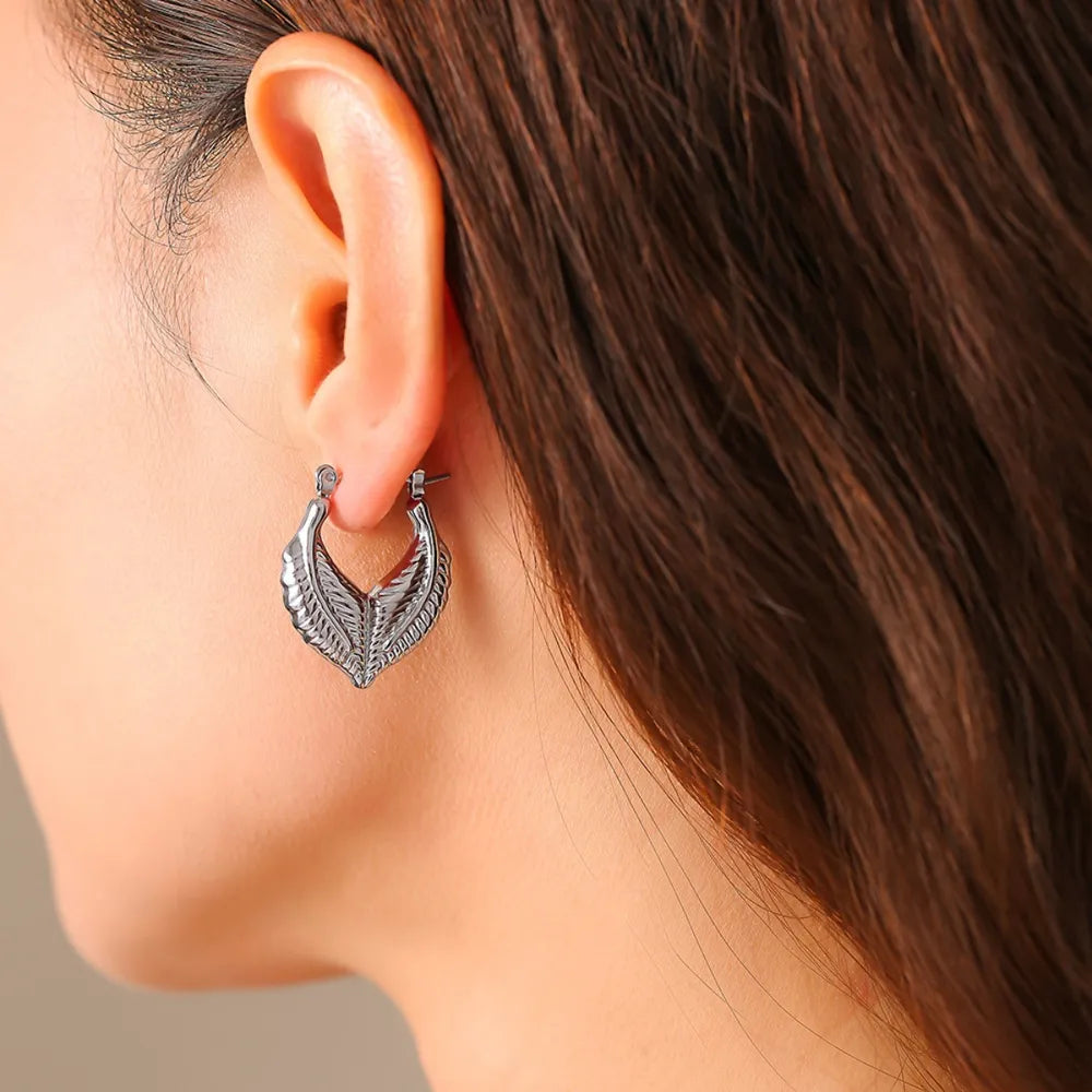 Silver leaf hoop earrings with textured detail