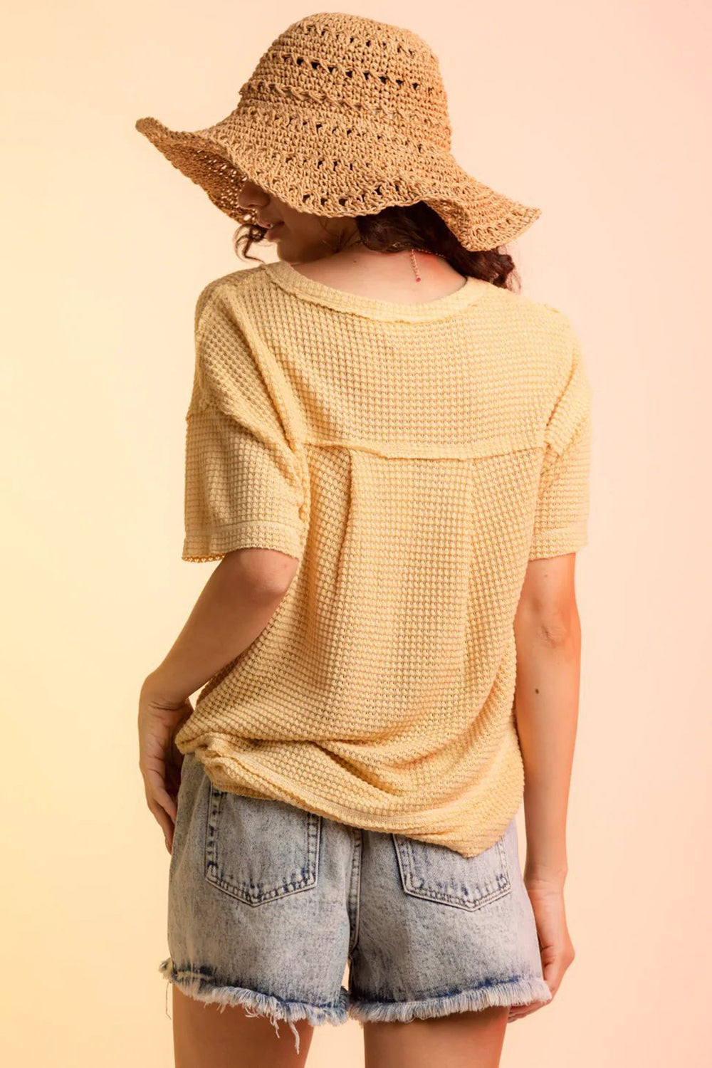 Yellow waffle knit V-neck top with short sleeves and a relaxed fit.