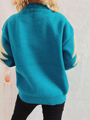Sky blue acrylic knit sweater with sequin-trimmed Christmas tree detail on sleeves.