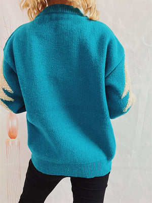Sky blue acrylic knit sweater with sequin-trimmed Christmas tree detail on sleeves.