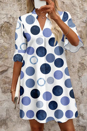Chic blue polka dot mini dress with v-neck and flounce sleeves.
