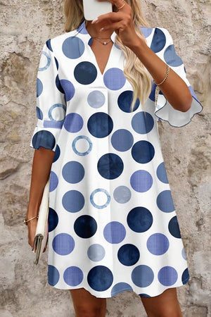 Chic blue polka dot mini dress with v-neck and flounce sleeves.