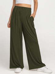 Army green pleated palazzo trousers with pockets and elastic waistband.