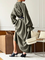 Army green cotton maxi dress with tie neck, ruffled cuffs, and a belted waist.
